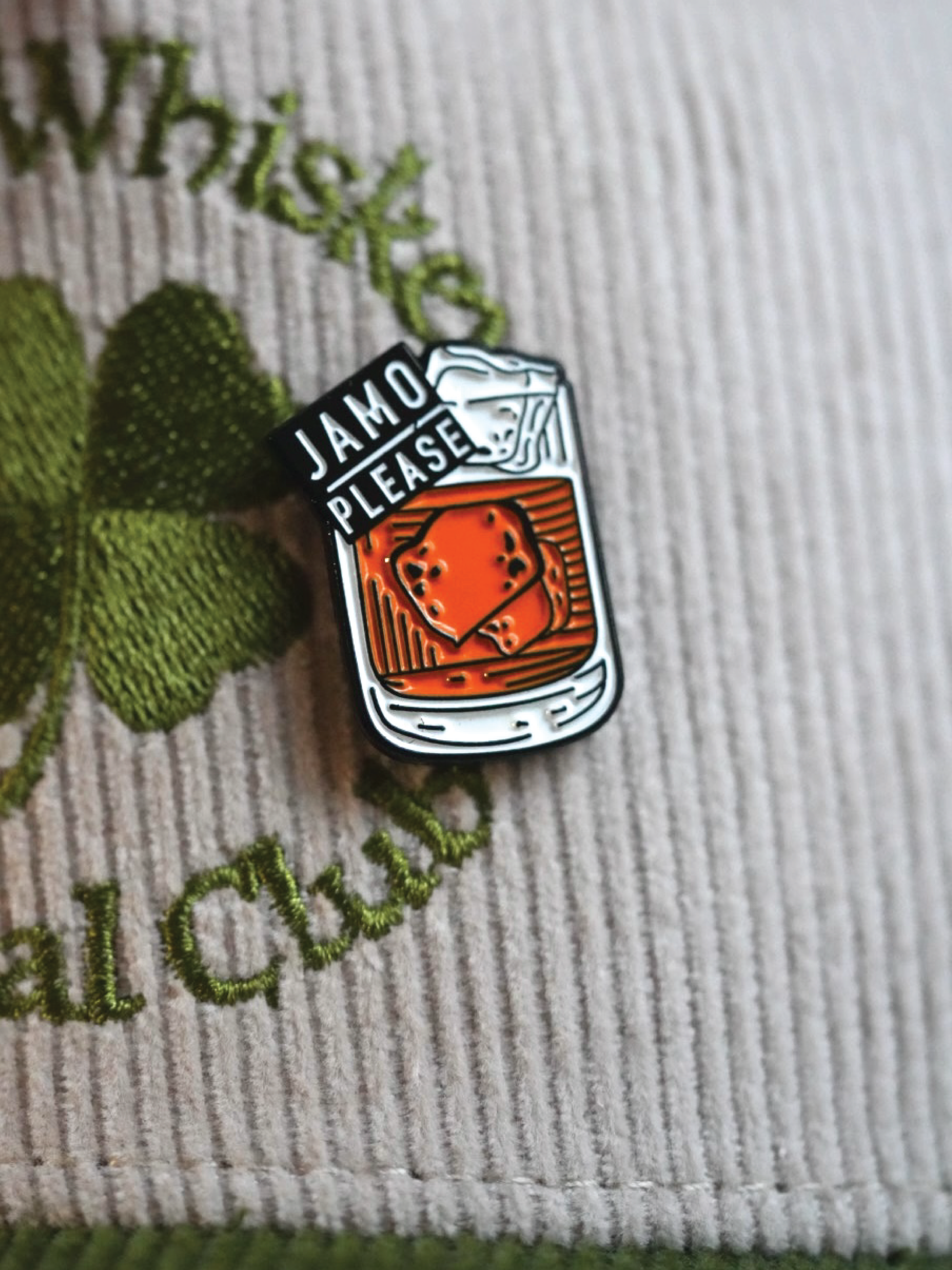 Jamo Please enamel pin on a hat, featuring Jameson Irish Whiskey design, ideal for St. Patrick's Day.