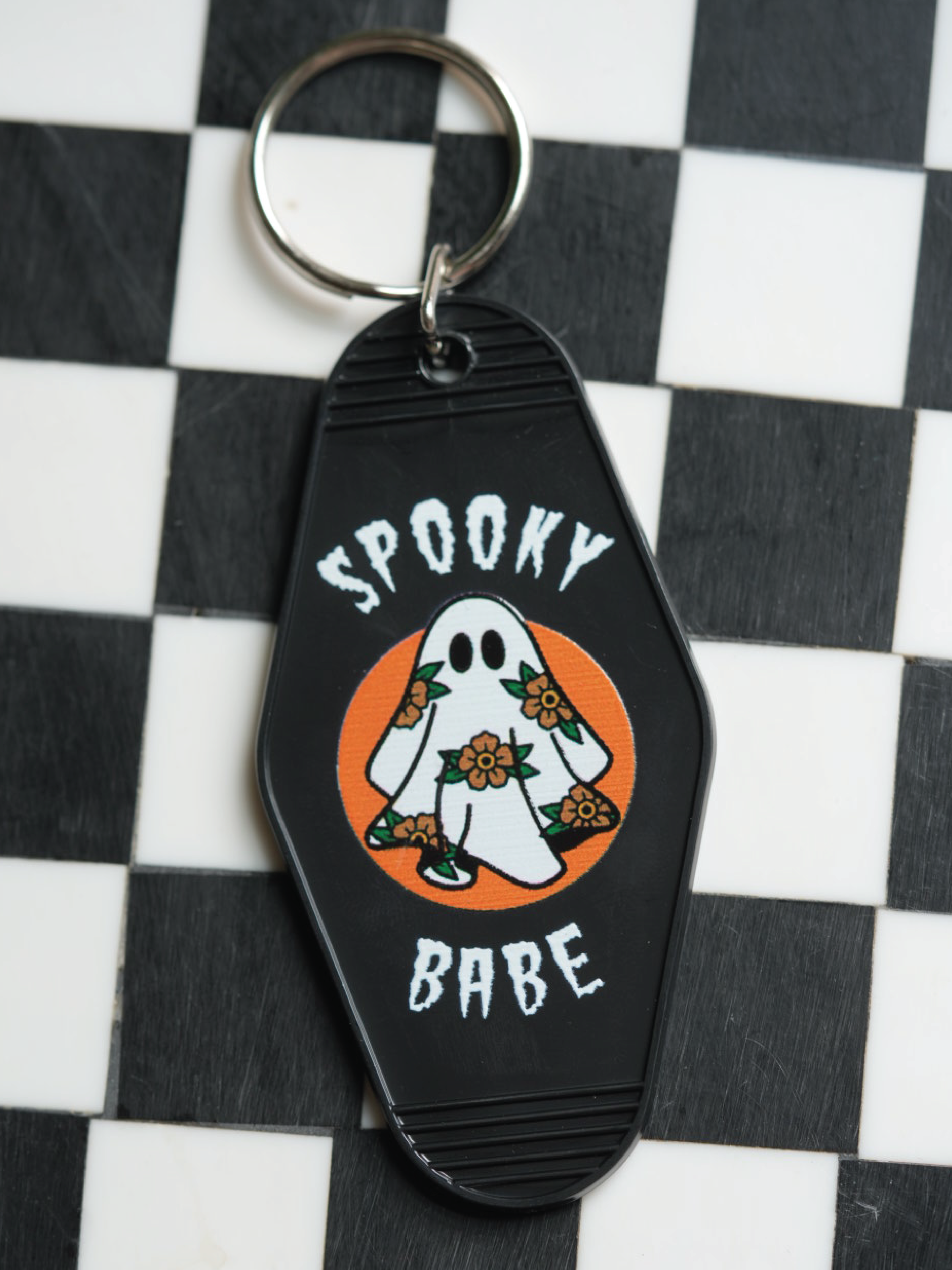 Unique spooky babe keychain featuring a ghost adorned with flowers, combining spooky vibes and vintage charm in one keychain. 