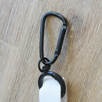 Close-up of the Moxxie White Leather Poop Bag Pouch’s durable matte black hook – perfect for easily attaching to your leash or purse!