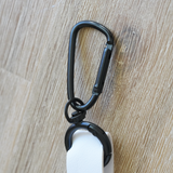 Close-up of the Moxxie White Leather Poop Bag Pouch’s durable matte black hook – perfect for easily attaching to your leash or purse!