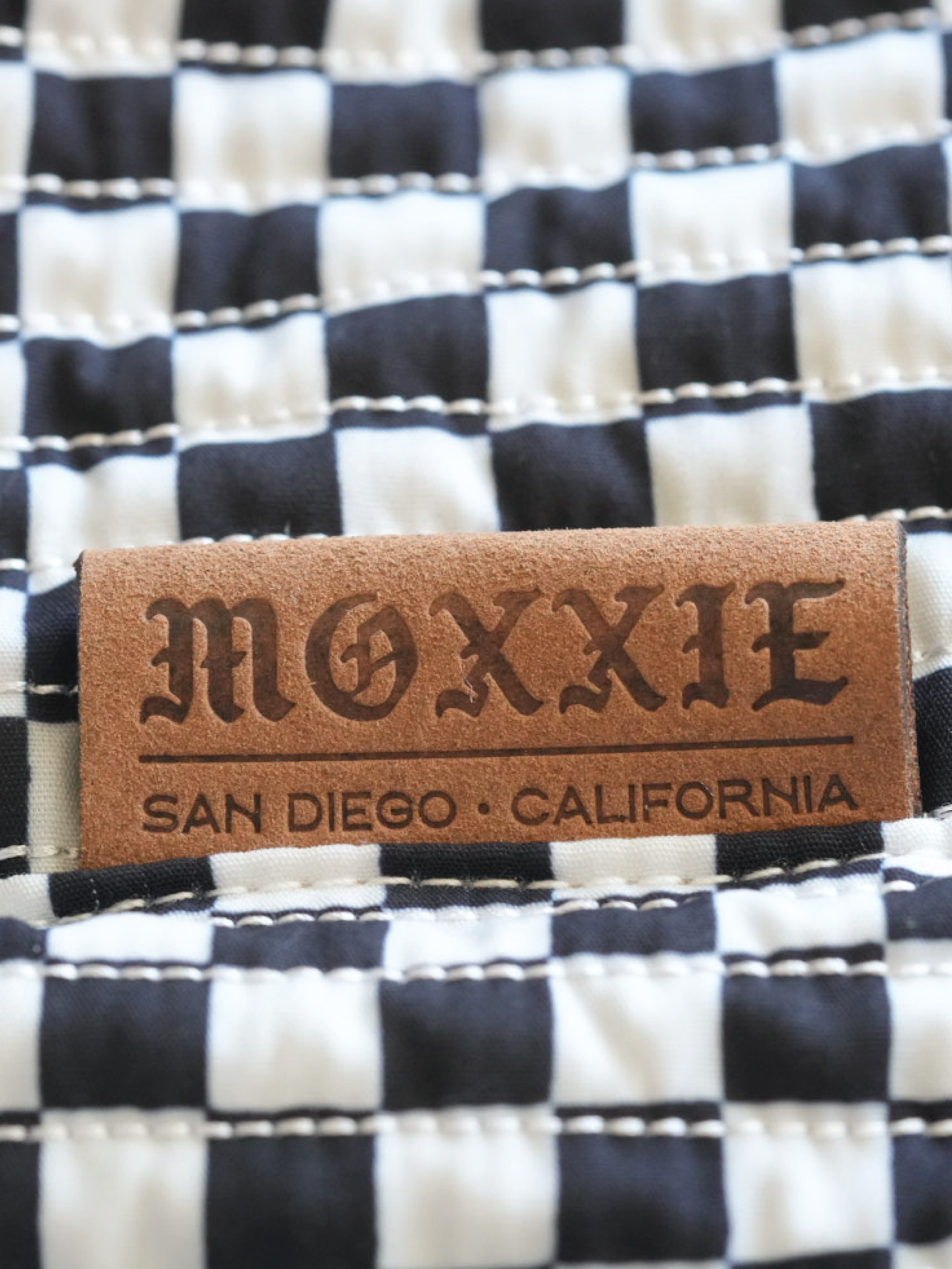 Moxxie stylish branded leather label. Moxxie Pet Sling Carrier – the perfect blend of style and function for pet lovers on the move.