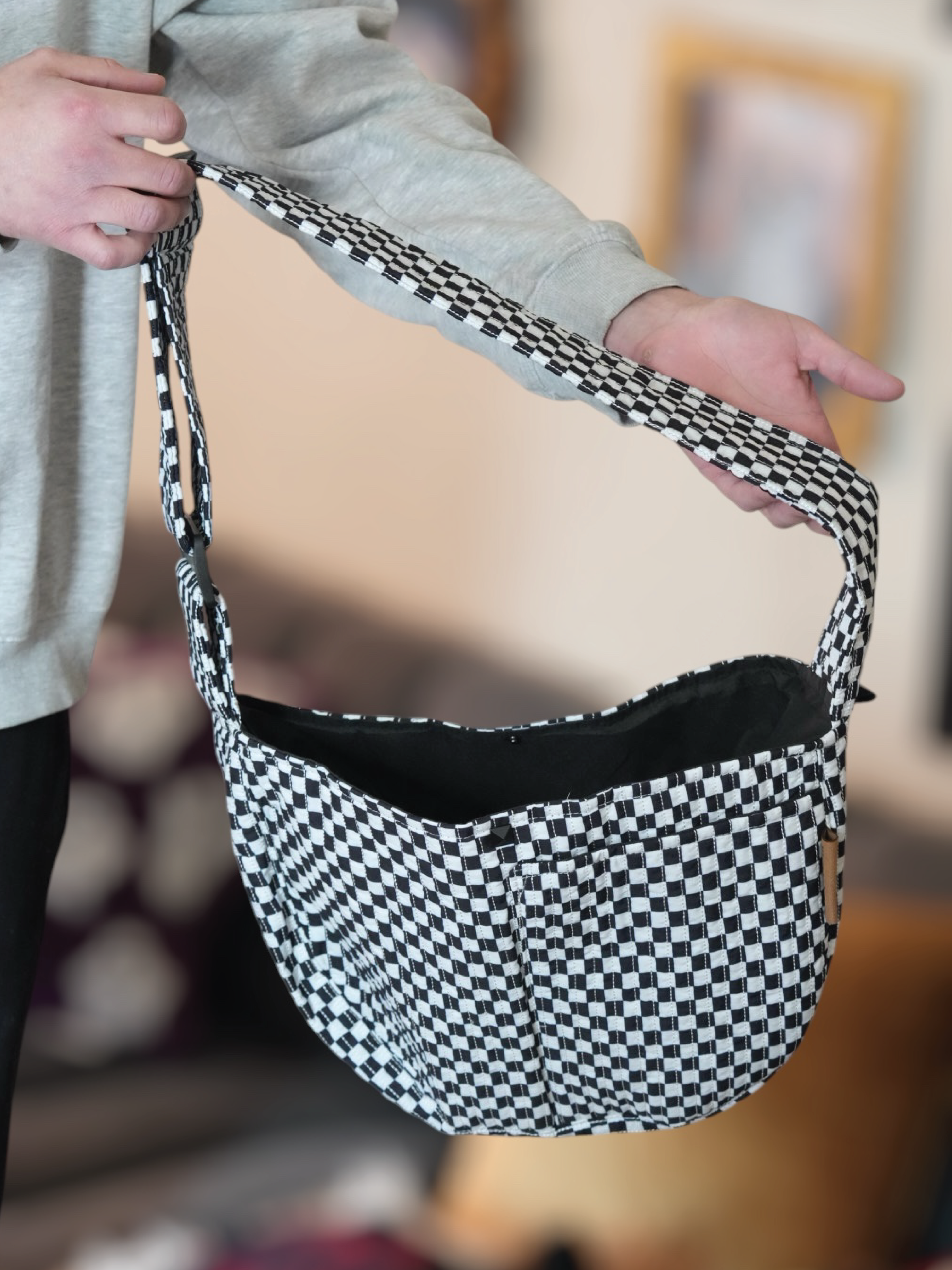 Hands-free comfort with the Moxxie Pet Sling Carrier – perfect for keeping your pet close and cozy on the go. Checkered pattern is perfect for emo vibes. 