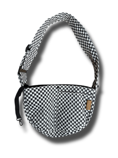 A small dog carrier sling in black and white checkers, designed for hands-free travel and walking. This adjustable, soft, and secure puppy carrier fits dogs and cats weighing 3-10 pounds.