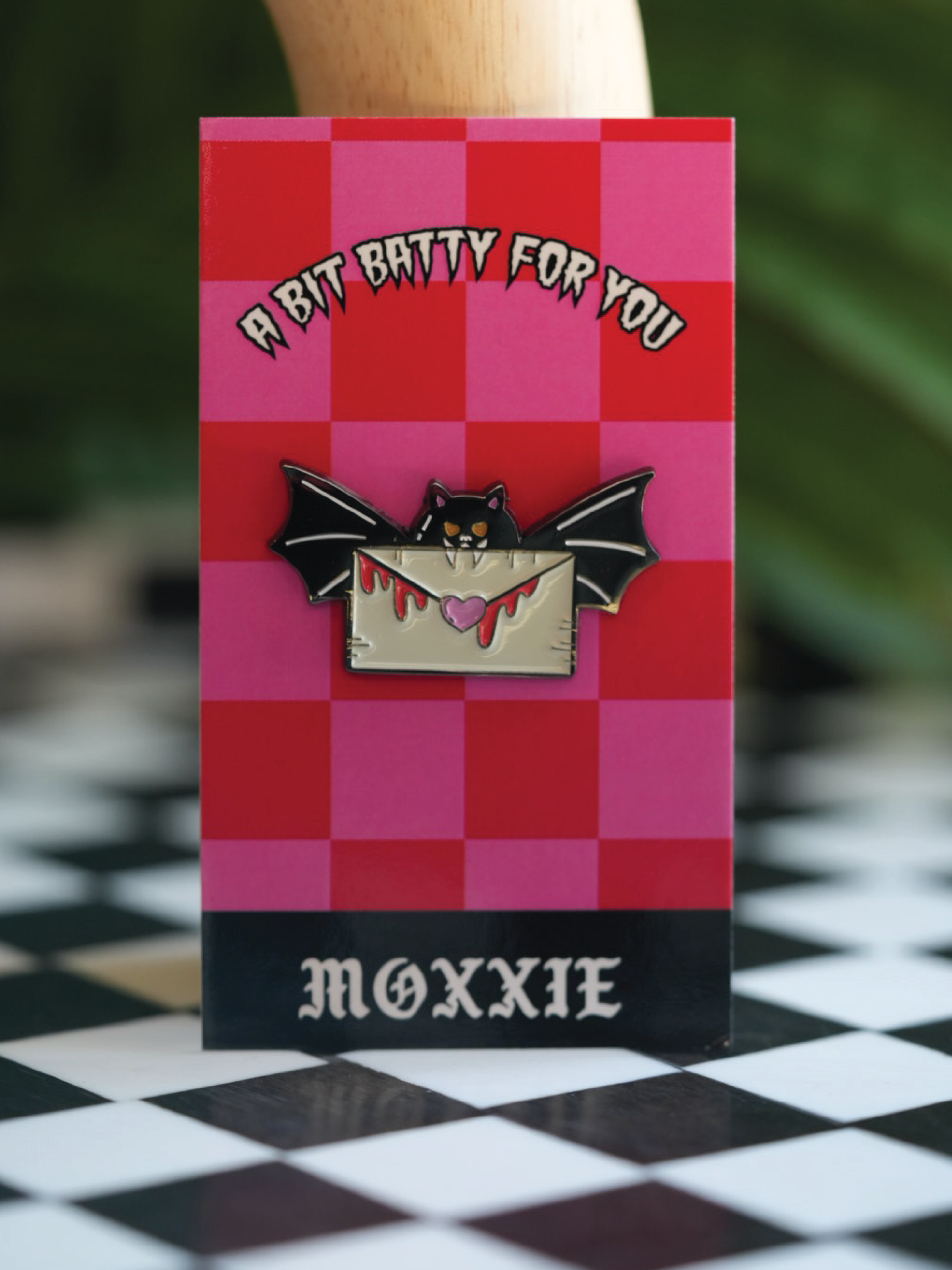 This spooky Batty for You pin is the ideal accessory for any Halloween enthusiast or spooky babe. Comes with a checkered red and pink backing. 