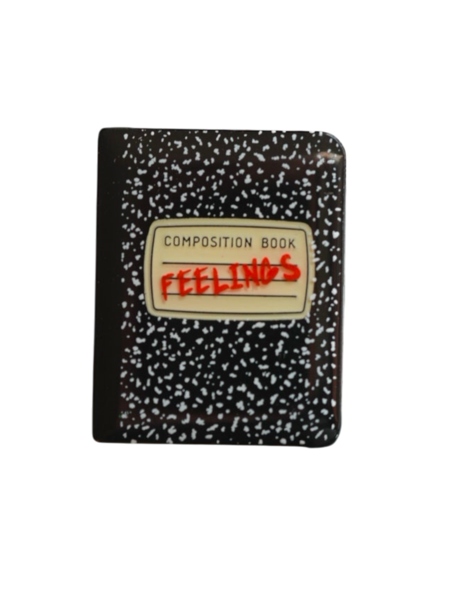 Feelings notebook pin, featuring a composition book design with doodles. 