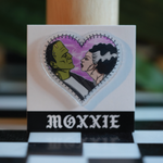 Frankenstein + Bride heart-shaped pin – a spooky, romantic addition to your pin collection for Halloween lovers.