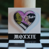 Frankenstein + Bride heart-shaped pin – a spooky, romantic addition to your pin collection for Halloween lovers.