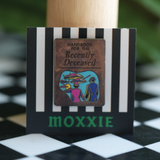 This Beetlejuice 2 enamel pin brings the ghostly vibes of the Handbook for the Recently Deceased to life with spooky charm.