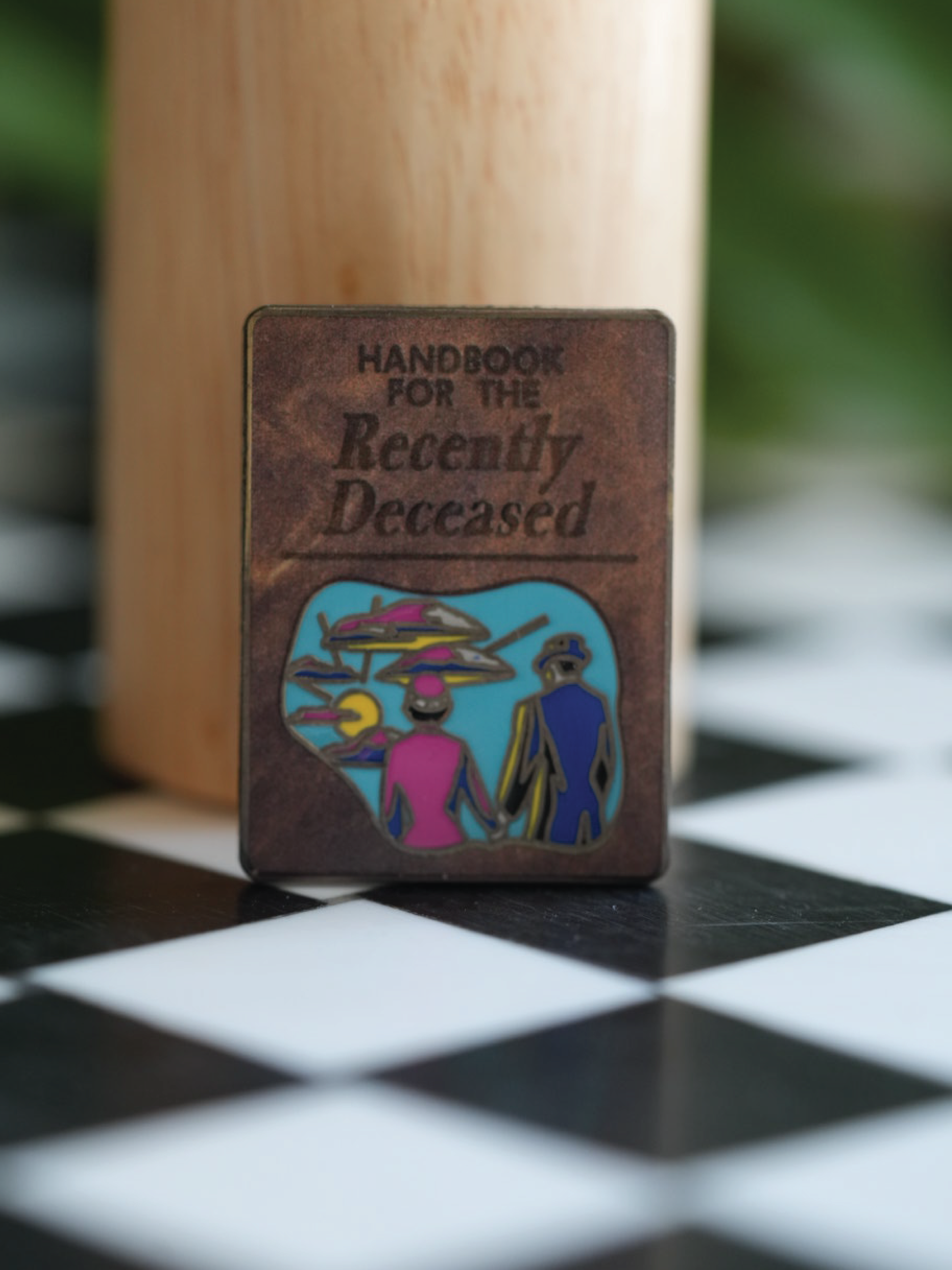 For spooky babes and horror lovers, this Beetlegeuse pin with the Handbook for the Recently Deceased is a must-have accessory.