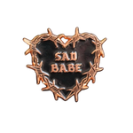Embrace your sad girl vibes with this Sad Babe pin, featuring a barbed wire heart and classic tattoo art.