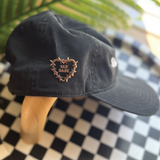 Sad Babe pin with a barbed wire heart and traditional tattoo design adds an edgy, emo touch to a Sad Diego Hat.