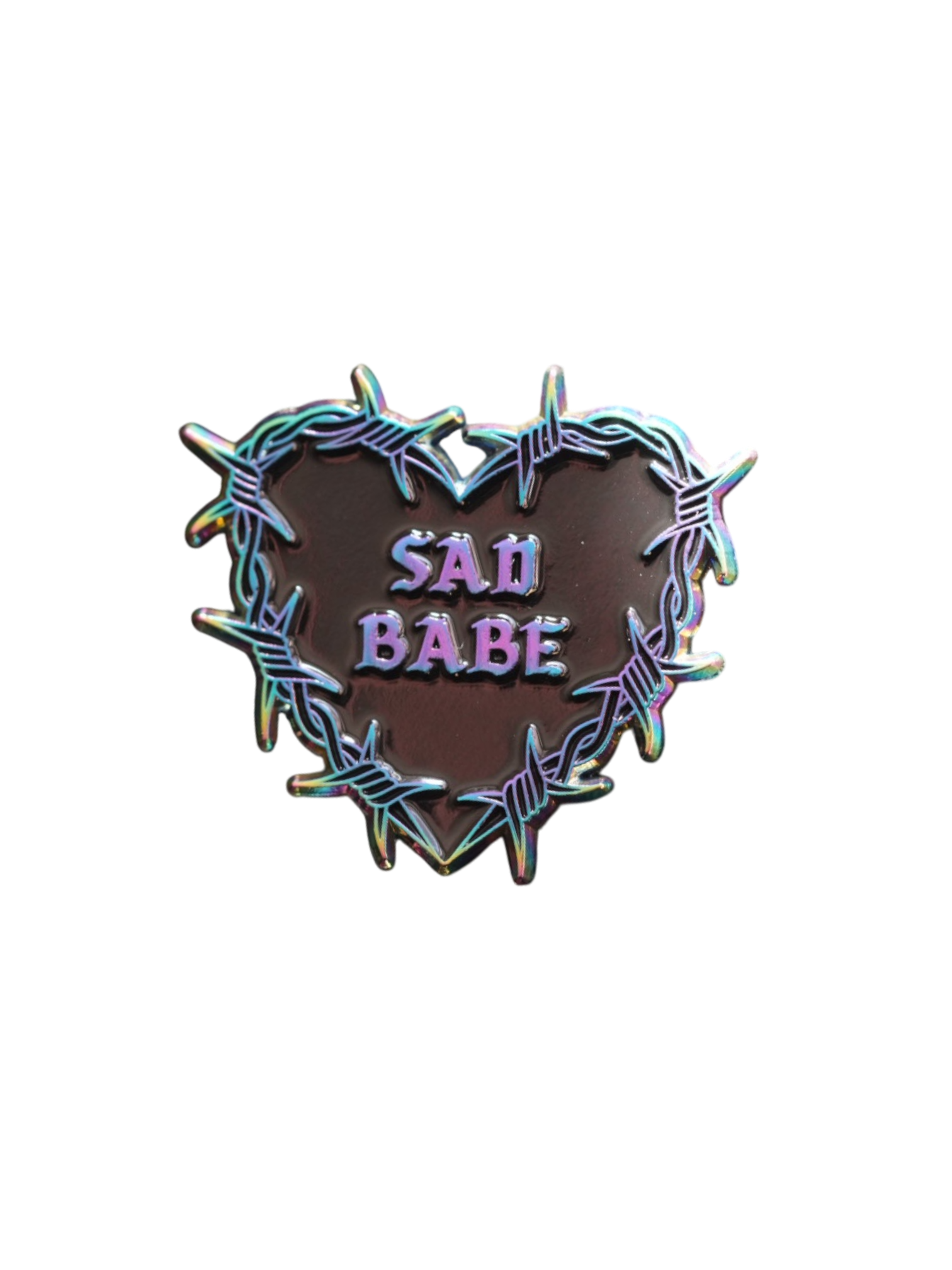 Add a metallic rainbow of color to your pin collection with this Sad Babe pin, featuring a barbed wire heart in rainbow metal and a traditional tattoo design.