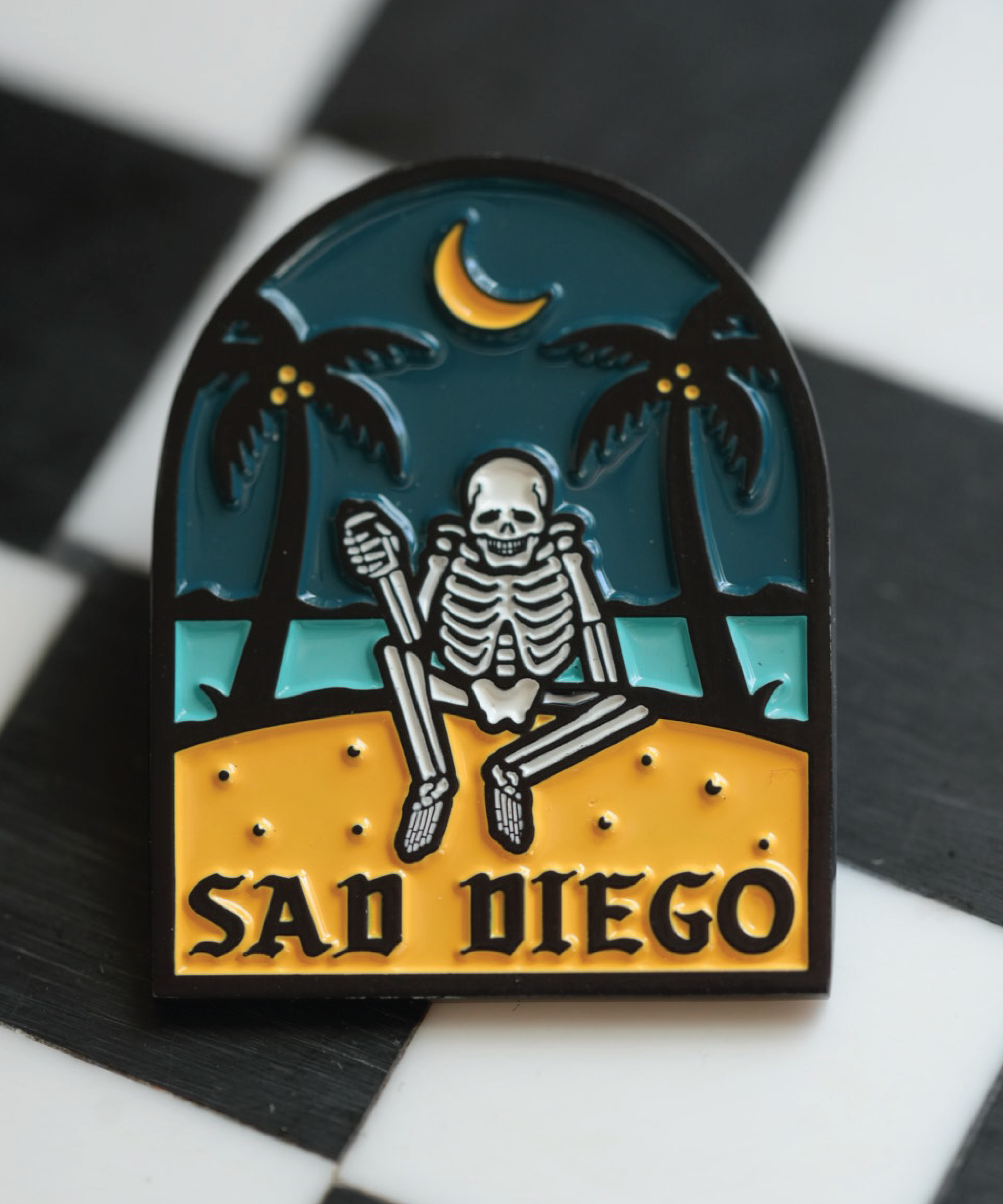 Emo-inspired Sad Diego pin with a skeleton and palm trees, adding a unique touch to your pin collection for Emo Night.