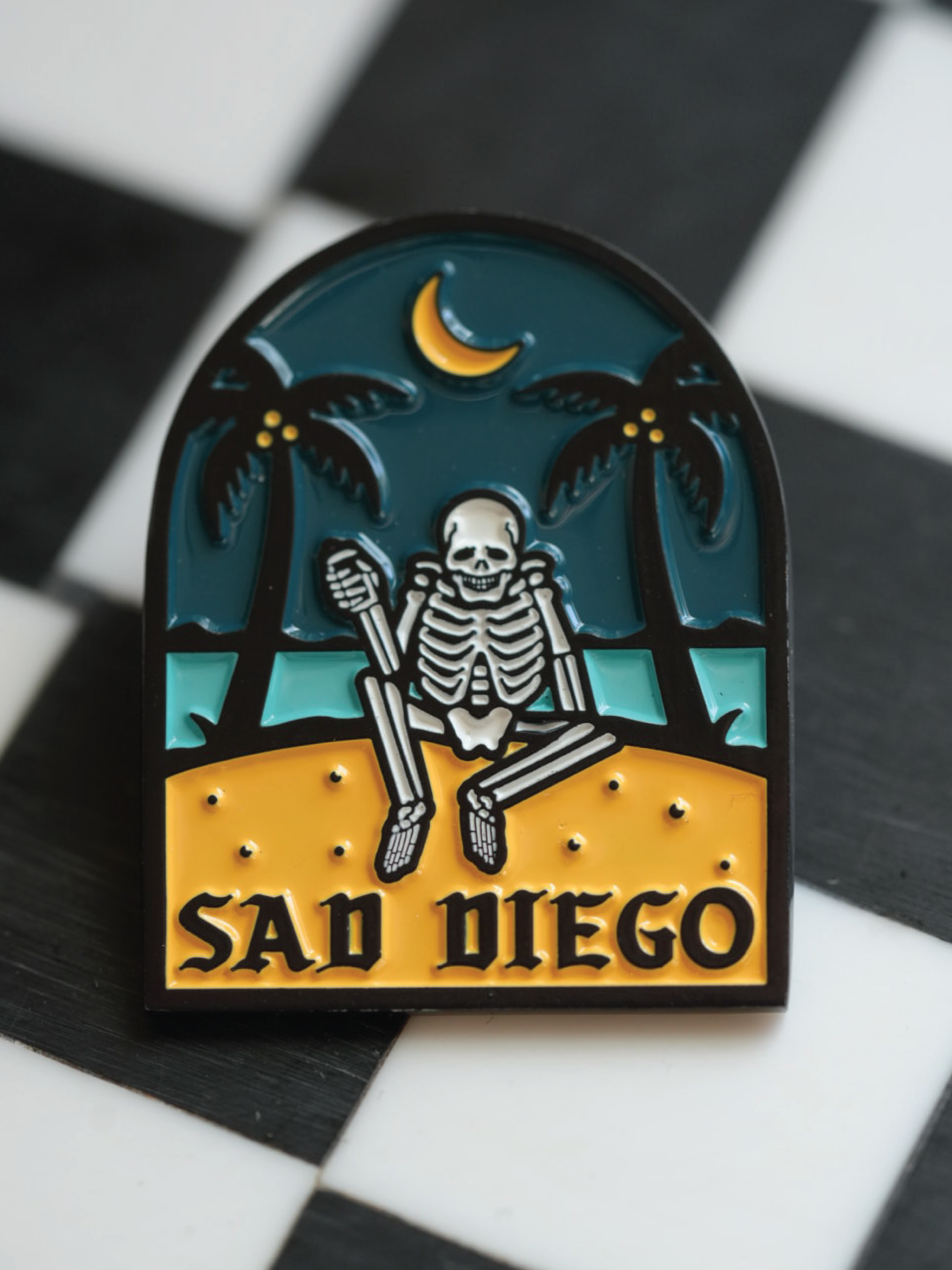 Emo-inspired Sad Diego pin with a skeleton and palm trees, adding a unique touch to your pin collection for Emo Night.