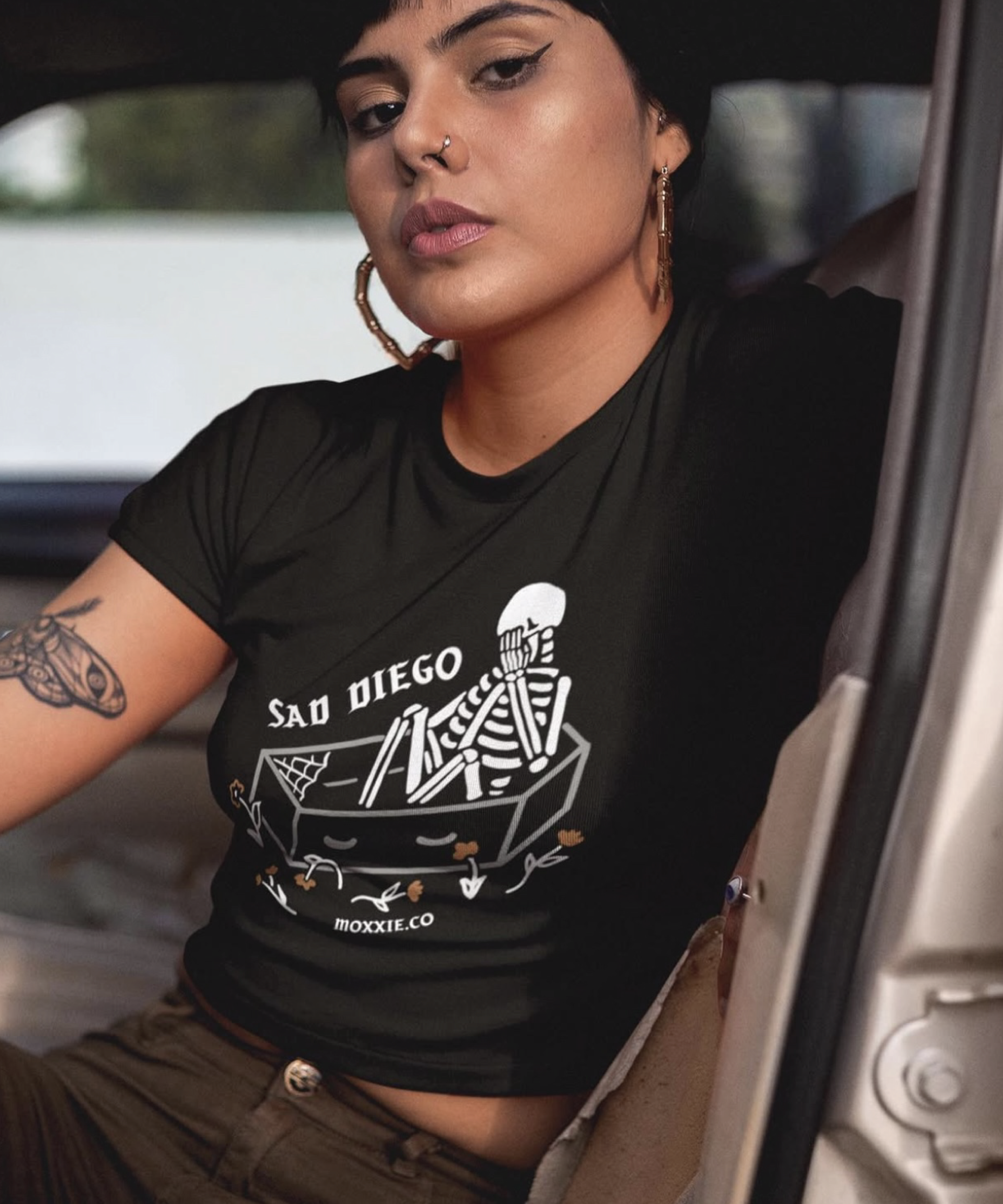 Sad Diego Coffin Crop Tee with a skeleton graphic—ideal for Emo Night enthusiasts and fans of bold, edgy fashion. A must-have crop top for any Sad Diego fan.