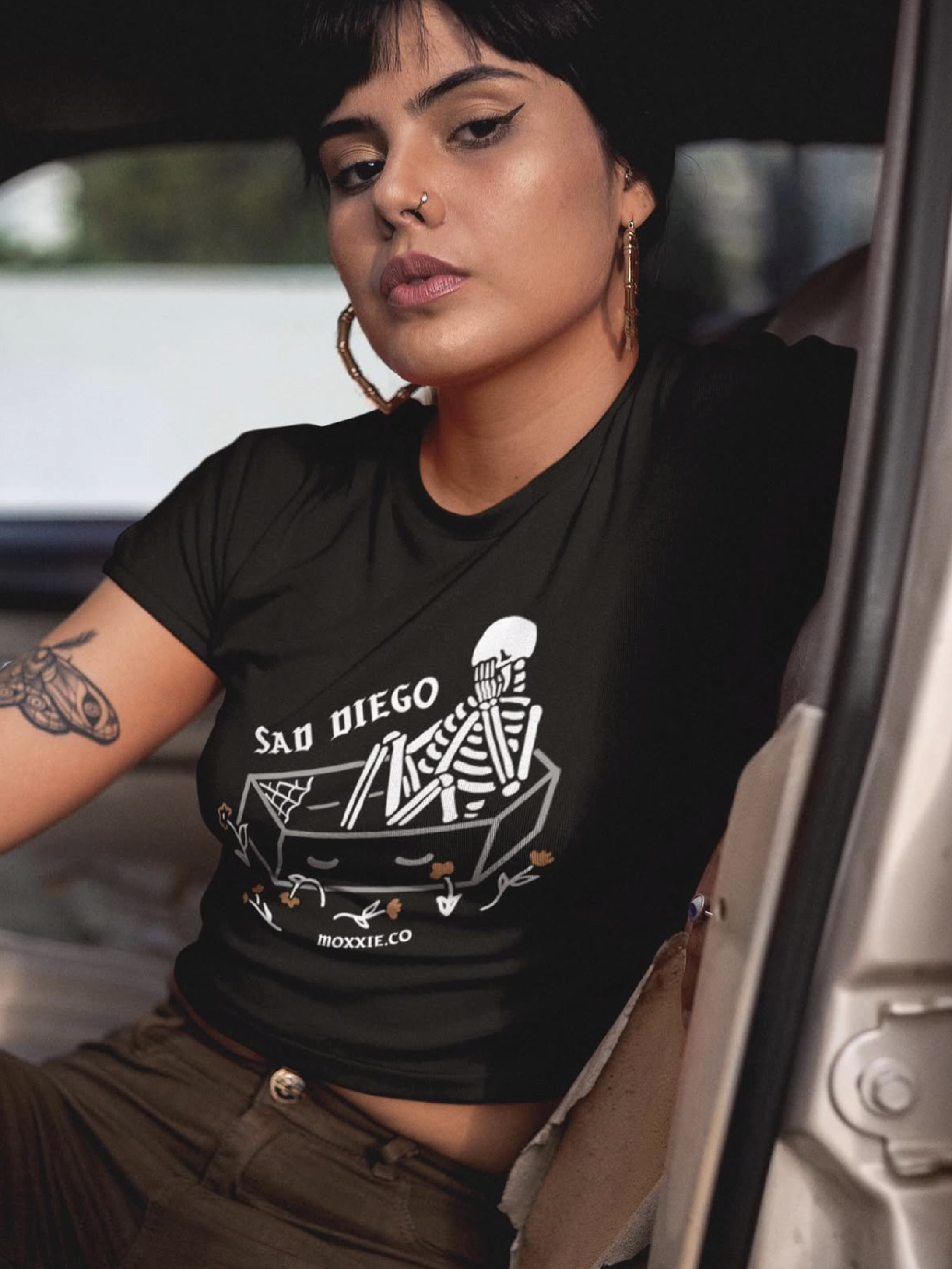 Sad Diego Coffin Crop Tee with a skeleton graphic—ideal for Emo Night enthusiasts and fans of bold, edgy fashion. A must-have crop top for any Sad Diego fan.
