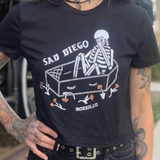 Sad Diego Coffin Crop Tee featuring a skeleton design, perfect for Emo Night lovers and fans of unique fashion. Show off your Sad Diego style with this edgy crop top.