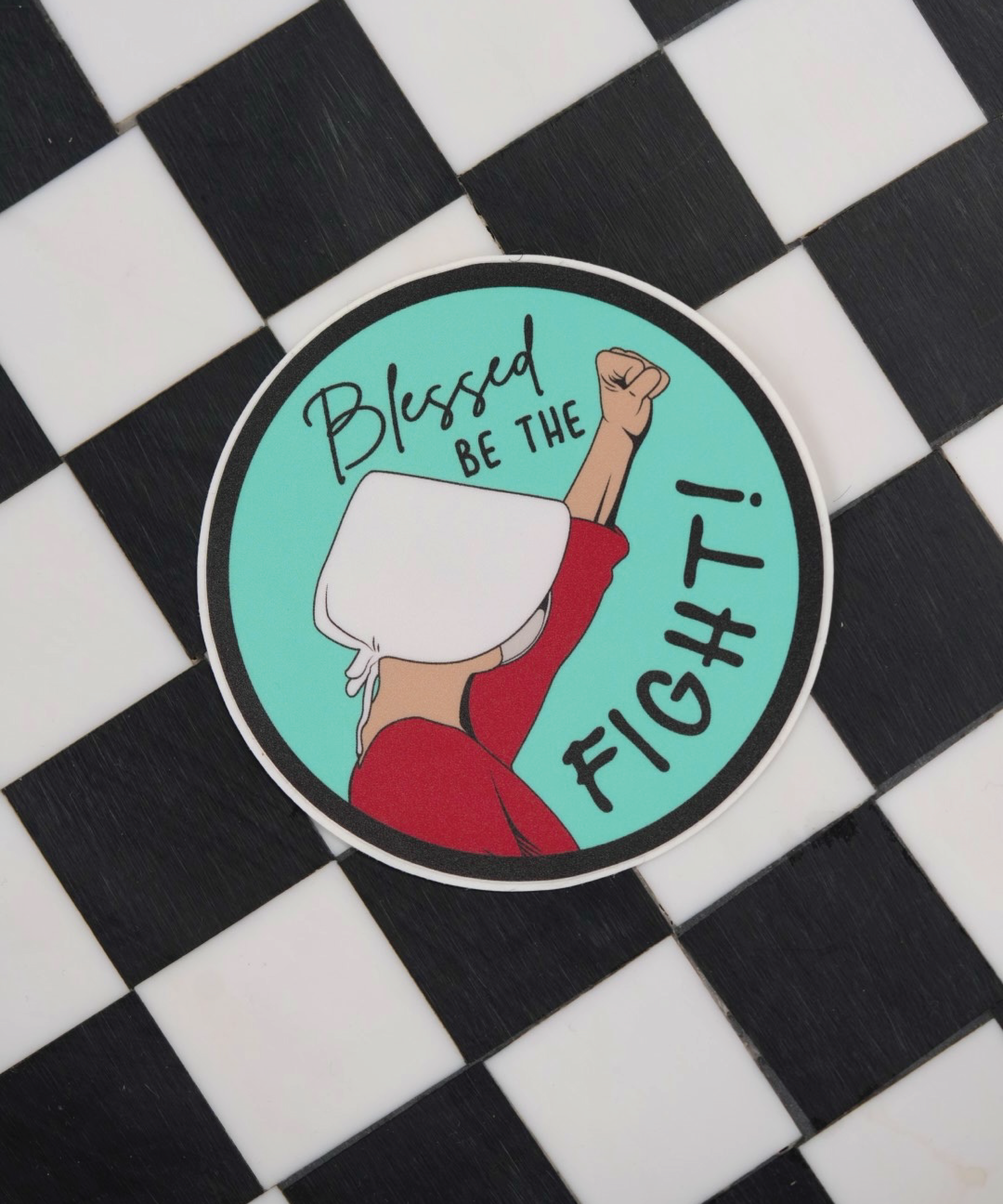 Feminist sticker featuring a Handmaid from The Handmaid's Tale, symbolizing the fight for women's rights, equal rights, and abortion rights in protest for women's healthcare and equality.