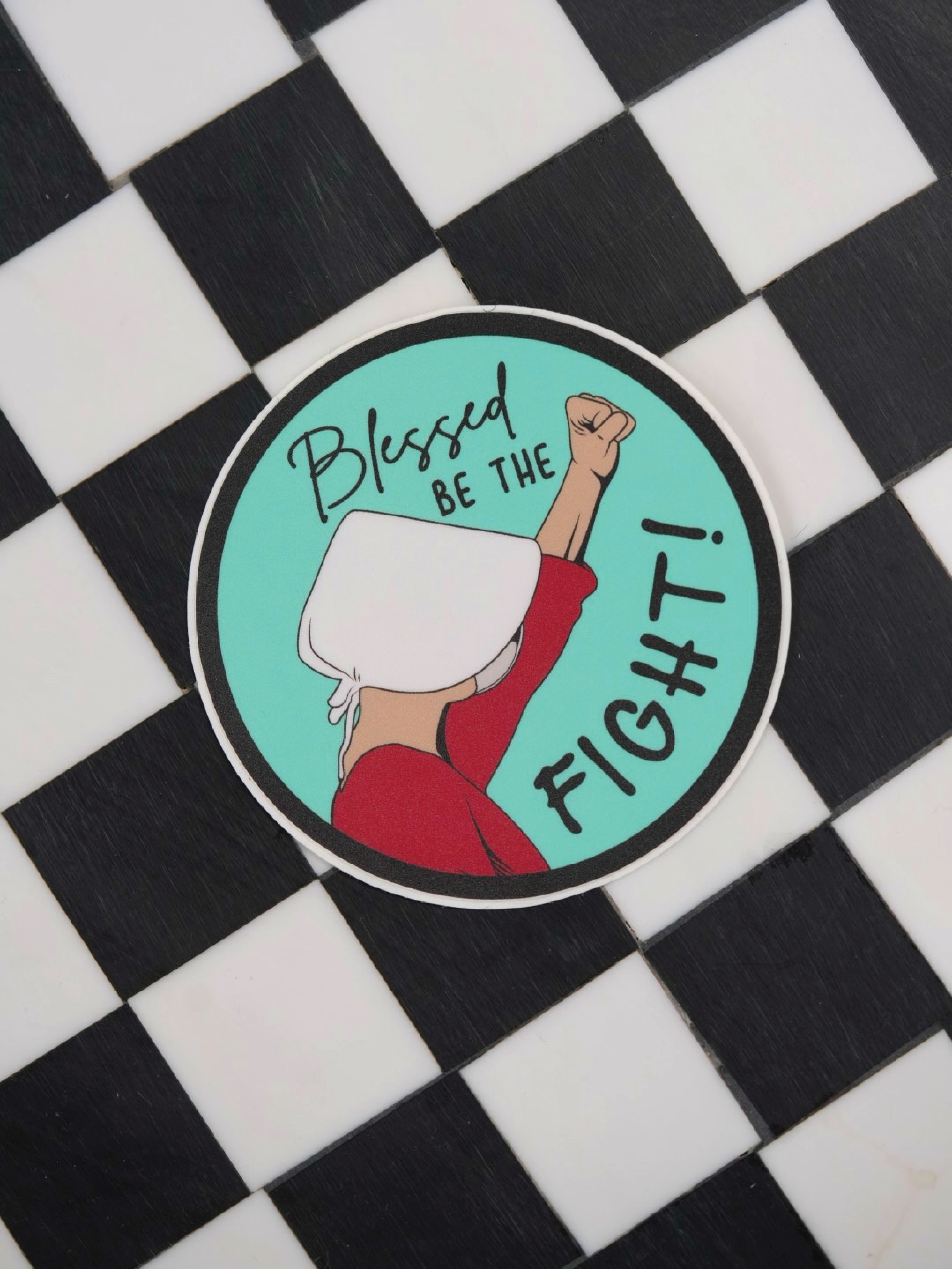 Feminist sticker featuring a Handmaid from The Handmaid's Tale, symbolizing the fight for women's rights, equal rights, and abortion rights in protest for women's healthcare and equality.