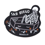 Emo-inspired 'Sad Diego Coffin Sticker' featuring a white skeleton in a coffin, perfect for sad boys, sad girls, and fans of emo nights with its dark, gothic vibe.