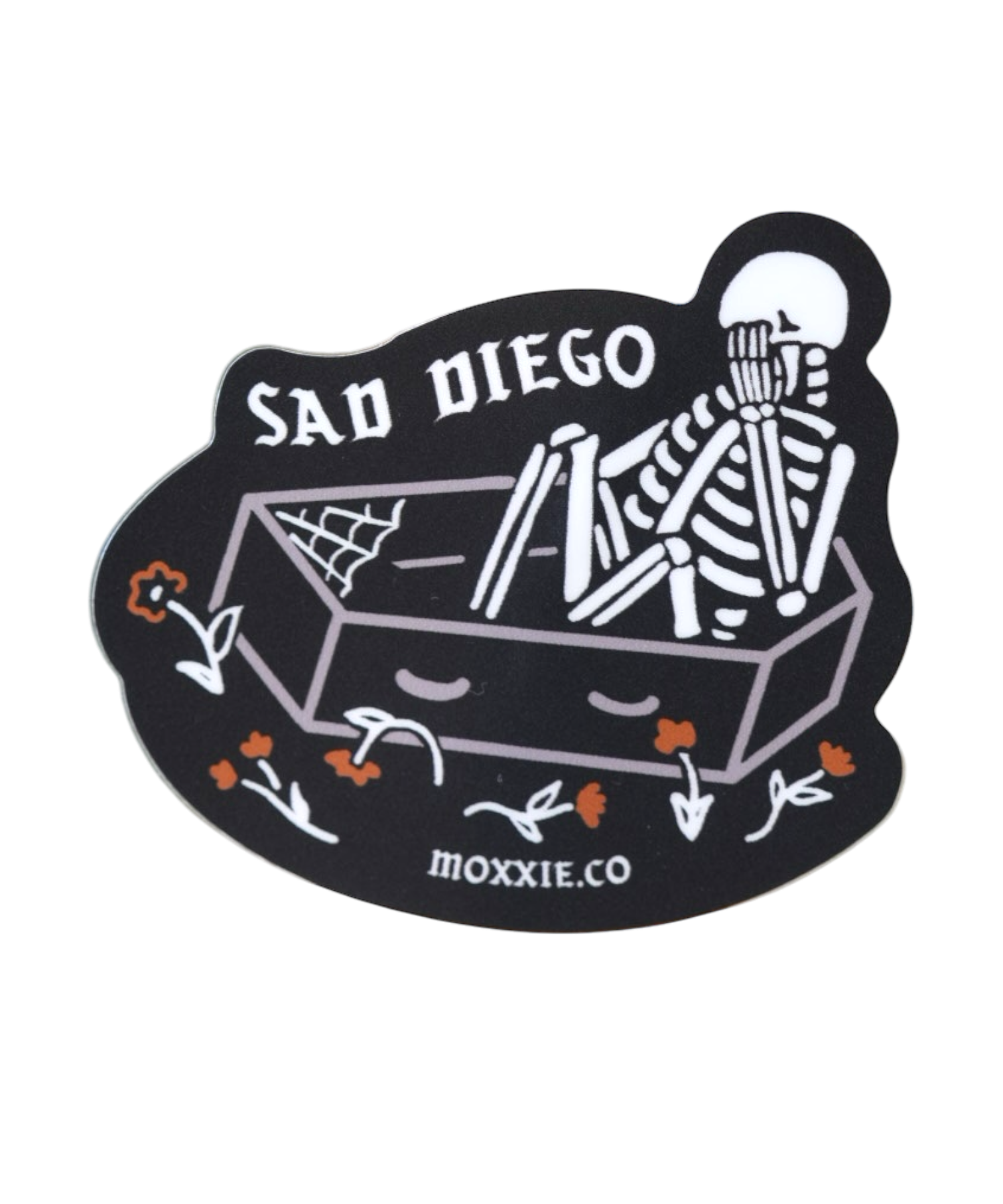 Emo-inspired 'Sad Diego Coffin Sticker' featuring a white skeleton in a coffin, perfect for sad boys, sad girls, and fans of emo nights with its dark, gothic vibe.