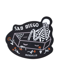 Emo-inspired 'Sad Diego Coffin Sticker' featuring a white skeleton in a coffin, perfect for sad boys, sad girls, and fans of emo nights with its dark, gothic vibe.
