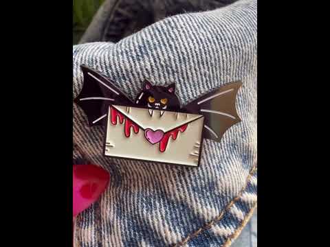 Add a touch of Halloween love to your outfit with this Batty for You pin, featuring a spooky bat and love letter.