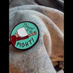 Close-up of the 'Blessed Be the Fight' enamel pin on a denim jacket, symbolizing equality and women's rights in a bold, feminist style.